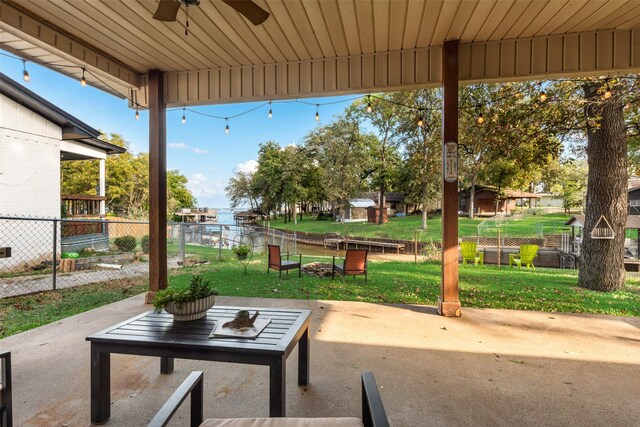 back of house with a lawn, a patio area, ceiling fan, and an outdoor living space