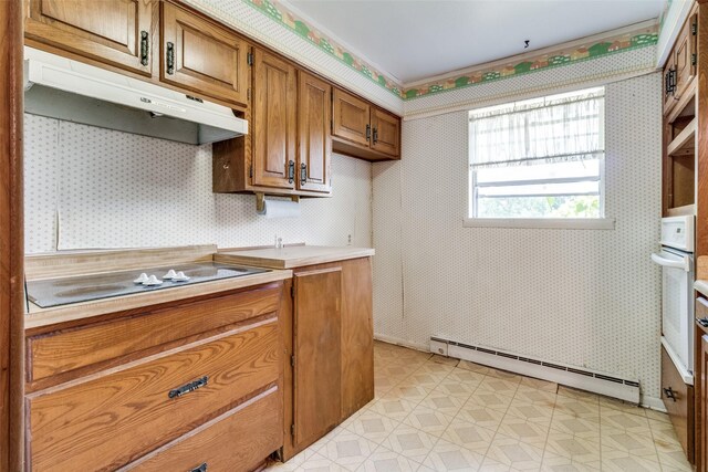 kitchen with white electric stovetop and a baseboard heating unit