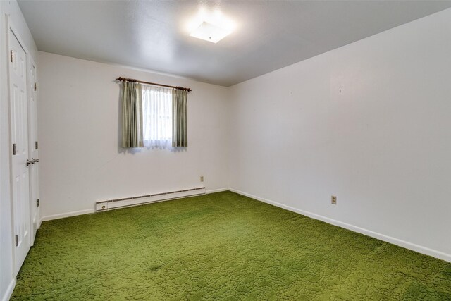 spare room with a baseboard radiator and carpet floors