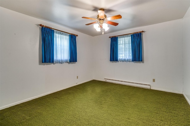 spare room featuring ceiling fan, carpet flooring, and a baseboard heating unit