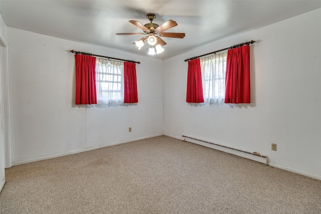 carpeted empty room featuring baseboard heating and ceiling fan