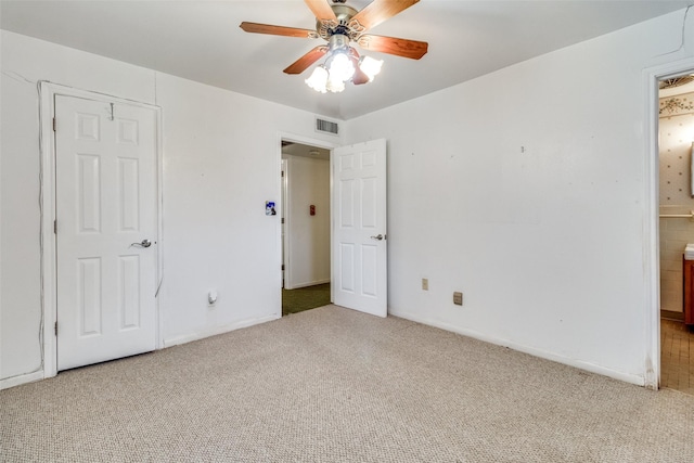 unfurnished bedroom featuring connected bathroom, ceiling fan, and light colored carpet