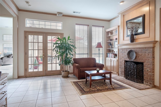 sitting room featuring crown molding, a fireplace, french doors, and light tile patterned floors