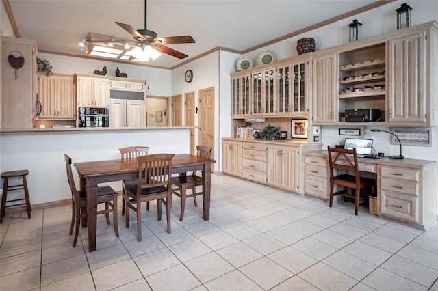 dining room with crown molding, ceiling fan, light tile patterned flooring, and built in desk