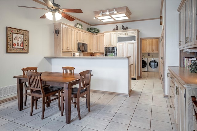 tiled dining room featuring ornamental molding, ceiling fan, and independent washer and dryer