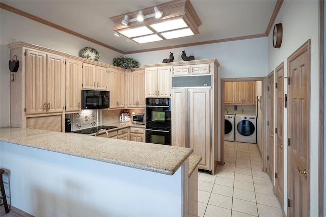 kitchen featuring light tile patterned flooring, black appliances, independent washer and dryer, kitchen peninsula, and crown molding