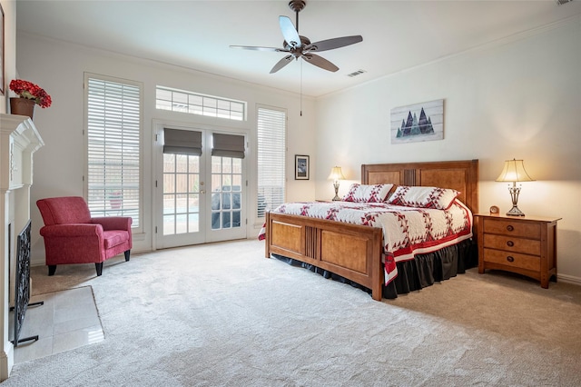 bedroom with multiple windows, crown molding, light colored carpet, and access to exterior