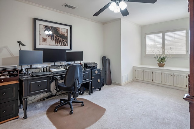 carpeted office featuring ornamental molding and ceiling fan