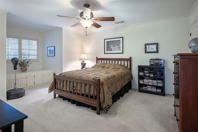 carpeted bedroom featuring crown molding and ceiling fan