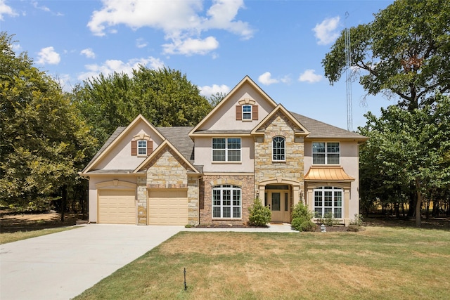 view of front facade with a front yard and a garage