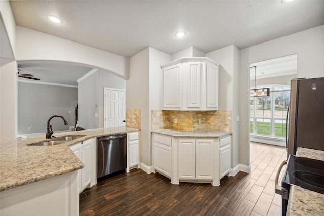 kitchen with white cabinetry, stainless steel appliances, ceiling fan, sink, and light stone counters