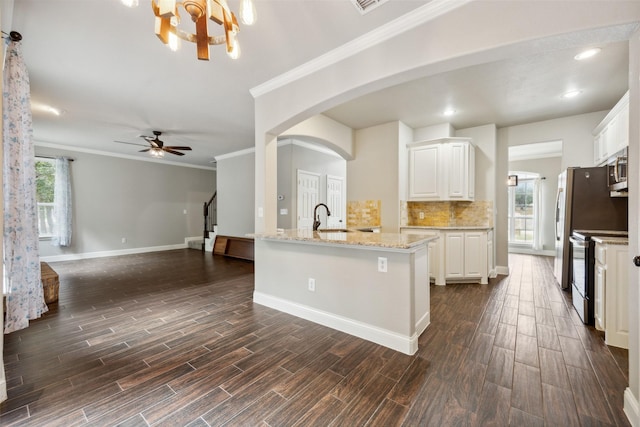 kitchen featuring white cabinetry, decorative backsplash, sink, light stone counters, and electric range