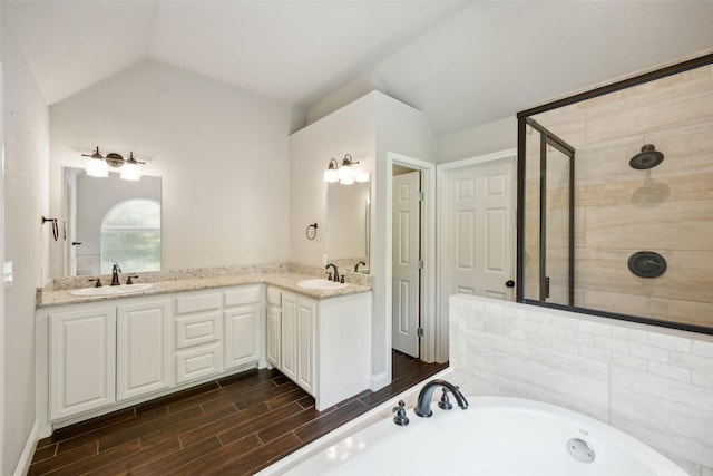 bathroom with vanity, lofted ceiling, and shower with separate bathtub