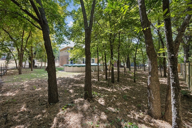 view of yard with a covered pool