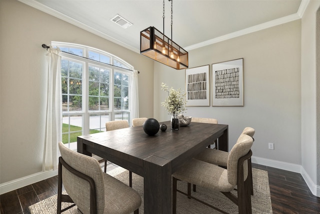 dining room with dark hardwood / wood-style floors and ornamental molding