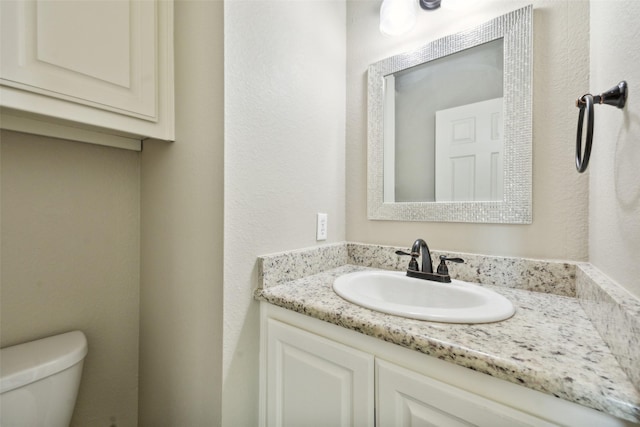 bathroom featuring toilet and vanity