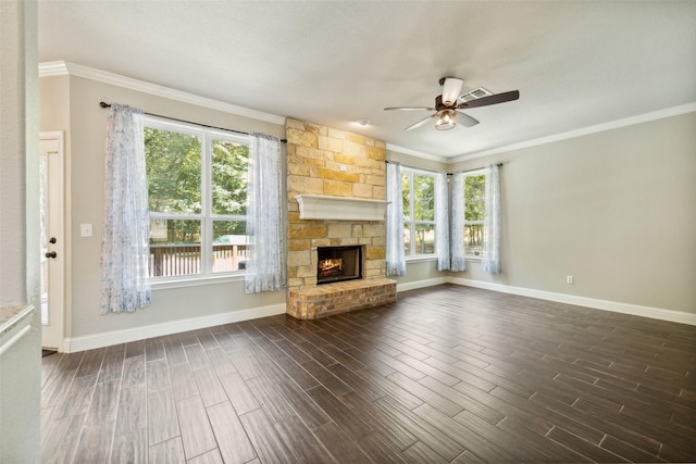 unfurnished living room featuring ceiling fan, a fireplace, plenty of natural light, and crown molding