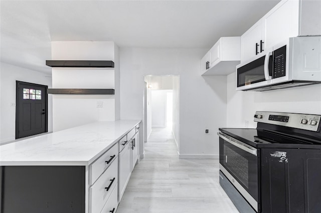 kitchen featuring white cabinetry, stainless steel electric stove, light stone countertops, and light hardwood / wood-style flooring