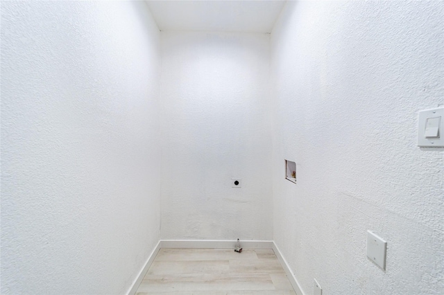 laundry room with electric dryer hookup, hookup for a washing machine, and light hardwood / wood-style floors