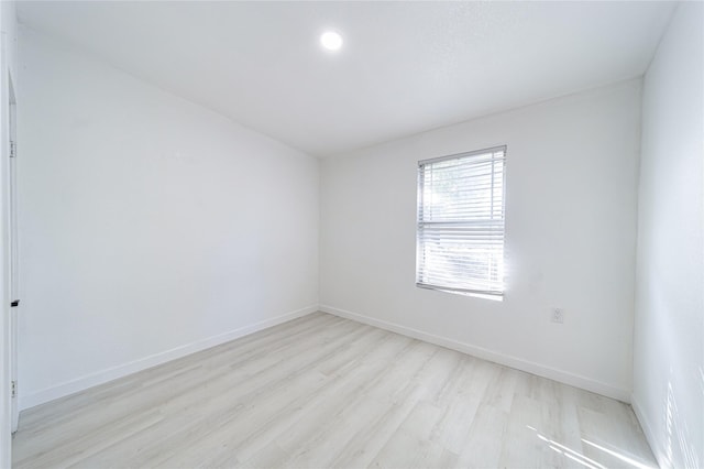 empty room with light hardwood / wood-style floors