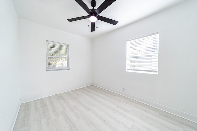 spare room with ceiling fan, light hardwood / wood-style flooring, and a wealth of natural light