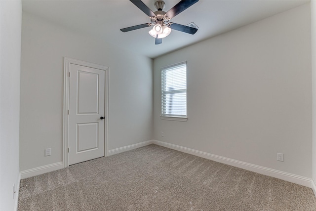 carpeted spare room featuring ceiling fan