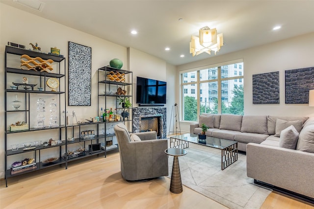 living room featuring a premium fireplace and light hardwood / wood-style flooring