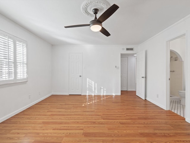 unfurnished bedroom with connected bathroom, ceiling fan, crown molding, and light hardwood / wood-style flooring