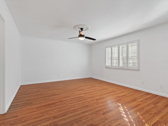 spare room with ornamental molding, ceiling fan, and hardwood / wood-style floors