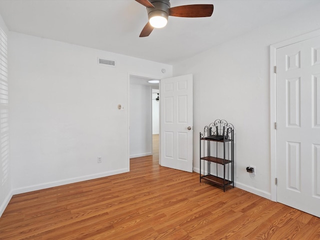 spare room featuring ceiling fan and light hardwood / wood-style floors