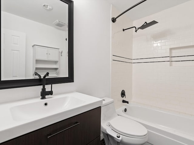 full bathroom with toilet, tiled shower / bath, and vanity