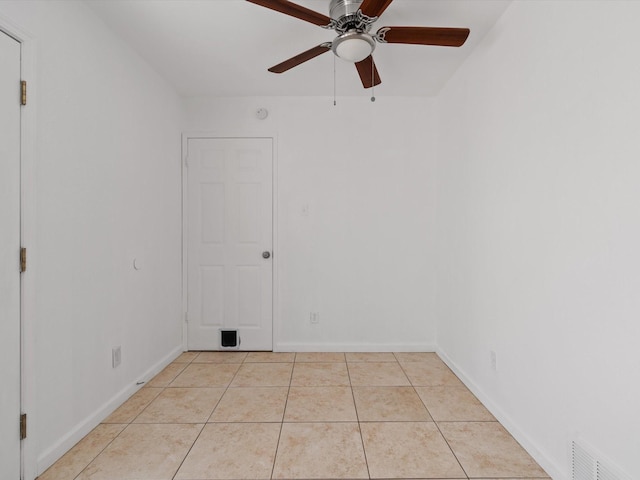 spare room with light tile patterned flooring and ceiling fan