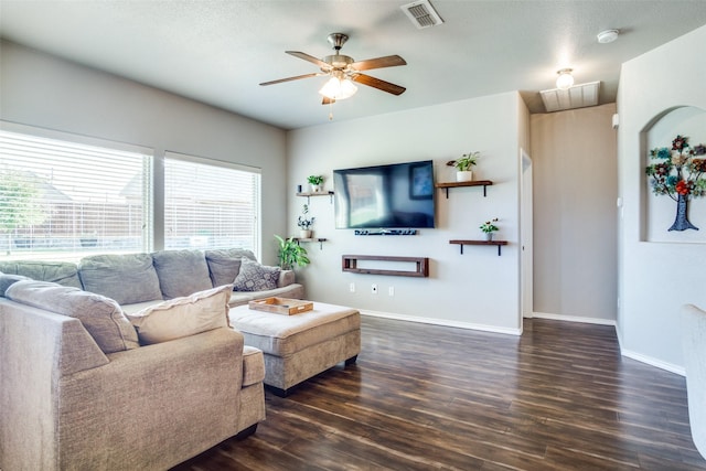 living room with ceiling fan and dark wood-type flooring