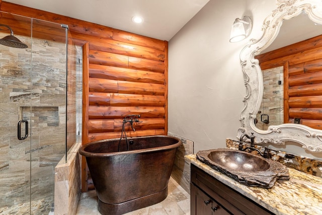 bathroom featuring vanity, log walls, and separate shower and tub