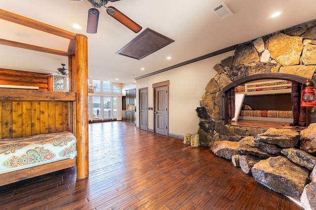 bedroom with ceiling fan, ornamental molding, and wood-type flooring