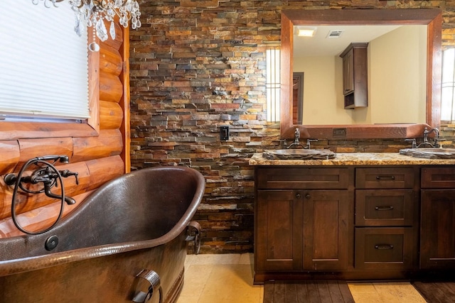 bathroom featuring vanity, log walls, and a bath