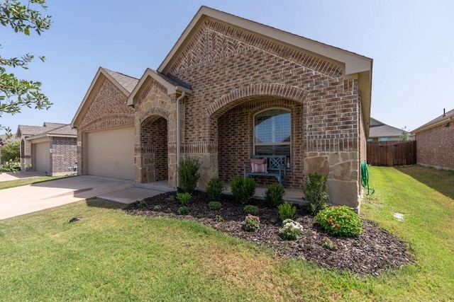 view of front of house featuring a garage and a front lawn