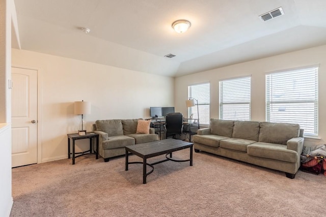 carpeted living room featuring a healthy amount of sunlight and vaulted ceiling