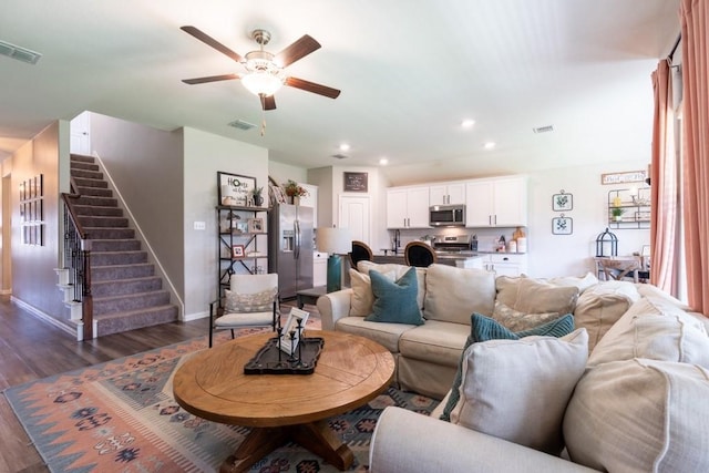 living room with ceiling fan and dark hardwood / wood-style floors