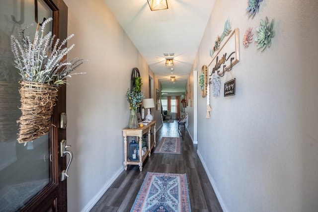 hallway with dark hardwood / wood-style flooring