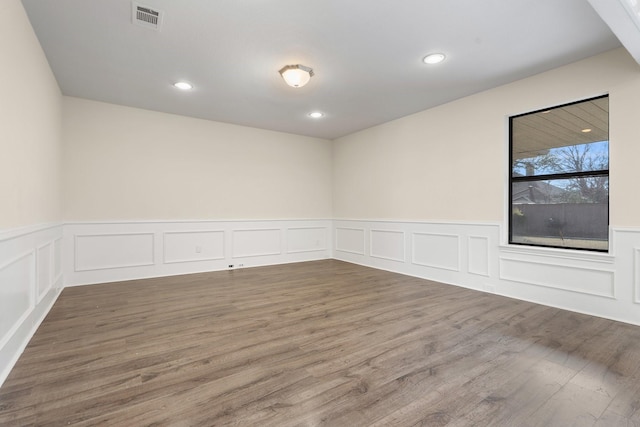 unfurnished room with hardwood / wood-style floors