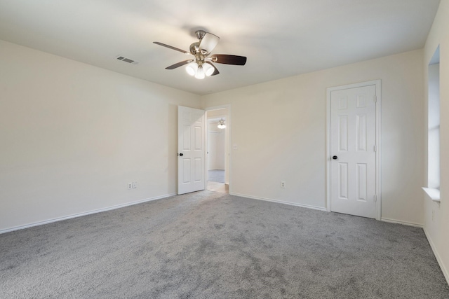 unfurnished room featuring ceiling fan and carpet floors