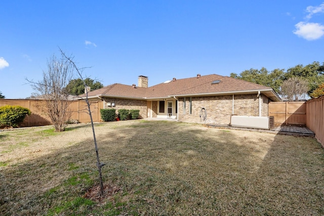 rear view of house with a lawn