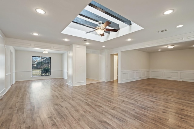 unfurnished living room featuring ceiling fan and hardwood / wood-style floors