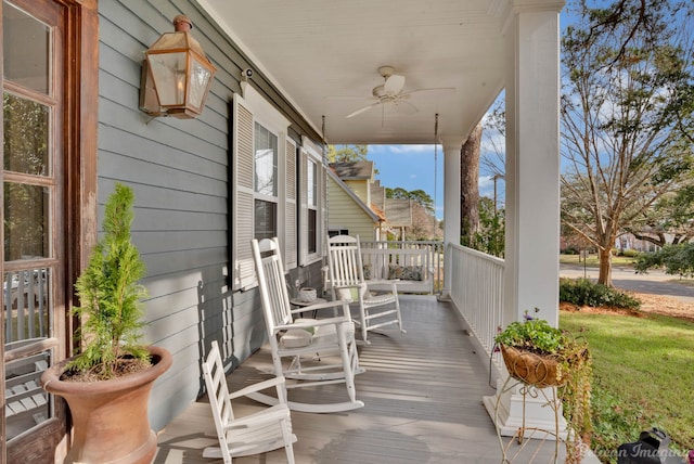 wooden terrace featuring ceiling fan and a porch