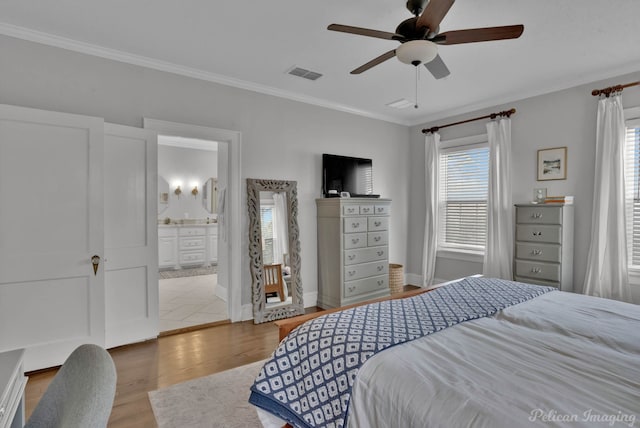 bedroom featuring ensuite bathroom, ceiling fan, crown molding, and light hardwood / wood-style floors