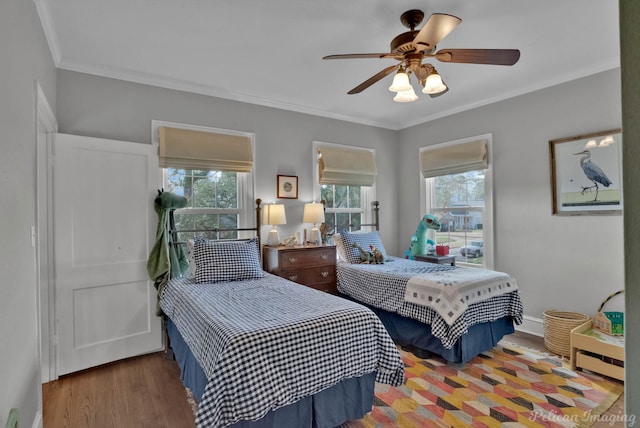 bedroom with ceiling fan, hardwood / wood-style floors, and crown molding