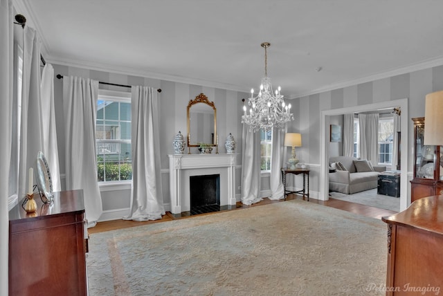 living room featuring an inviting chandelier, ornamental molding, and light hardwood / wood-style flooring