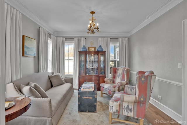 living room featuring a notable chandelier, crown molding, and light hardwood / wood-style flooring