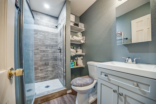 bathroom featuring wood-type flooring, toilet, an enclosed shower, and vanity